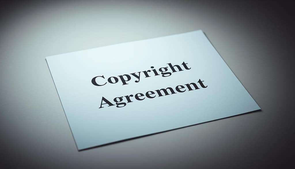 A legal document with a formal, authoritative appearance lies at the center of the frame. The text "Copyright Transfer Agreement" is clearly visible, surrounded by a neutral background that conveys a sense of professionalism and legality. The document is illuminated by soft, directional lighting, casting subtle shadows and highlights that add depth and dimension to the scene. The camera angle is slightly elevated, providing a clear, unobstructed view of the agreement. The overall mood is one of seriousness and significance, reflecting the importance of the subject matter. A legal document with a formal, authoritative appearance lies at the center of the frame. The text "Copyright Transfer Agreement" is clearly visible, surrounded by a neutral background that conveys a sense of professionalism and legality. The document is illuminated by soft, directional lighting, casting subtle shadows and highlights that add depth and dimension to the scene. The camera angle is slightly elevated, providing a clear, unobstructed view of the agreement. The overall mood is one of seriousness and significance, reflecting the importance of the subject matter.